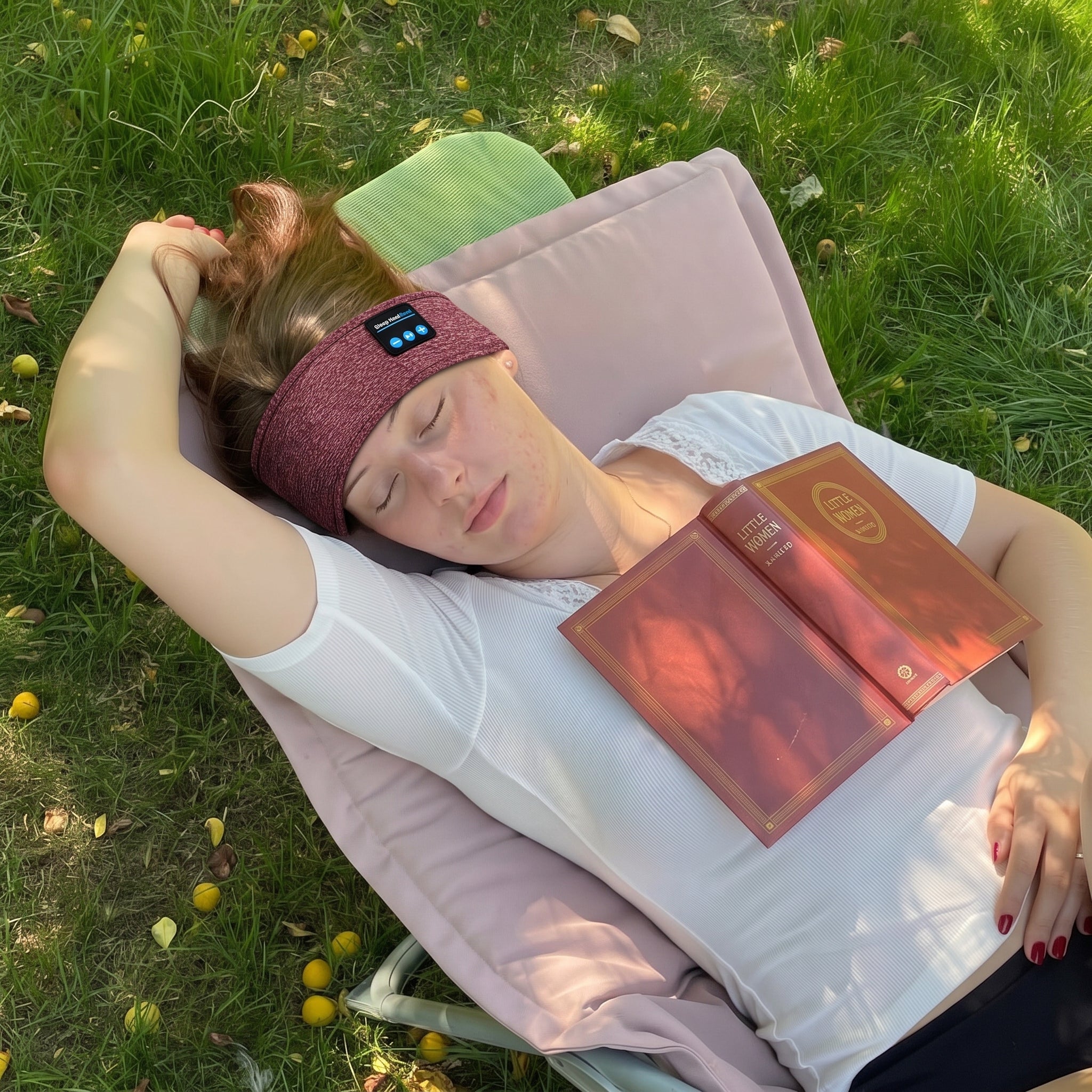 Lying in a park wearing the band, book resting on chest